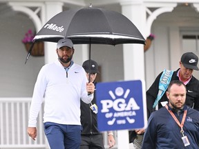 Scottie Scheffler and his caddie, Ted Scott, walk to the driving range during the second round of the 2024 PGA Championship.