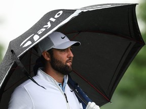 Scottie Scheffler looks on from the 12th tee from under his umbrella during the second round of the 2024 PGA Championship.