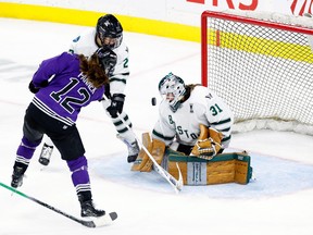 Aerin Frankel of Boston makes a save against Kelly Pannek of Minnesota in the third period in Game 4r of the PWHL Finals.