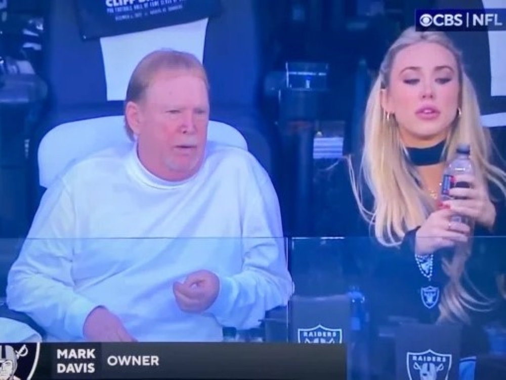 Las Vegas Raiders owner Mark Davis sits next to dancer Hayden Hopkins.