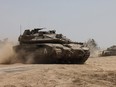 Israeli tanks roll near the border
