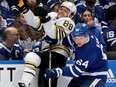 David Kampf of the Toronto Maple Leafs checks David Pastrnak of the Boston Bruins.