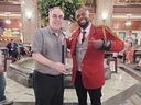 Honorary Duckmaster Donald Duench (left) poses with Duckmaster Kenon Walker in front of the lobby fountain at The Peabody Memphis in Memphis, Tenn.