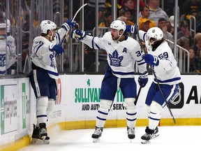 William Nylander, left, of the Toronto Maple Leafs celebrates with Auston Matthews, centre, and Tyler Bertuzzi after scoring a goal on Jeremy Swayman of the Boston Bruins during the third period in Game 7 of the First Round of the 2024 Stanley Cup Playoffs at TD Garden on May 4, 2024 in Boston.