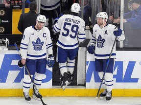 Toronto Maple Leafs forward Tyler Bertuzzi leaves the ice between John Tavares and Morgan Rielly.