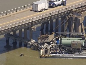 Oil spills into the surrounding waters after a barge hit a bridge.