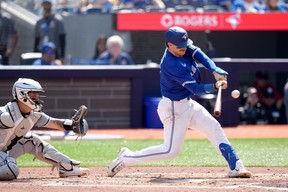 Blue Jays catcher Danny Jansen hits an RBI double during the third inning against the Chicago White Sox in Toronto, Monday, May 20, 2024.