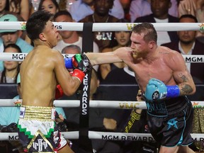 Canelo Alvarez (right) hits Jaime Munguia in the seventh round of their undisputed super middleweight championship fight at T-Mobile Arena on May 4, 2024 in Las Vegas, Nevada.