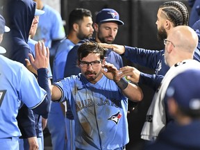 Blue Jays sparkplug Davis Schneider celebrates with teammates after scoring during the eighth inning against the Chicago White Sox on Tuesday.