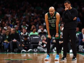 Boston Celtics coach Joe Mazzulla talks with Derrick White, left, during the third quarter of game five of the Eastern Conference First Round Playoffs at TD Garden on May 1, 2024 in Boston.