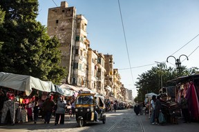 A tuk-tuk (motorized rickshaw) moves along a market road along the tracks of the Alexandria tramway network in Egypt's northern coastal city of Alexandria on Nov. 24, 2023.