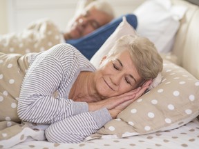 Senior couple sleeping comfortably.