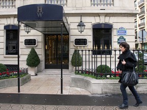 A woman walks in front of the ultra-luxury jewellery house Harry Winston