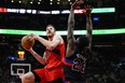 Toronto Raptors centre Jakob Poeltl (19) attacks the net while guarded by Detroit Pistons centre Isaiah Stewart.