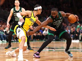 Jaylen Brown, right, of the Boston Celtics drives past Andrew Nembhard of the Indiana Pacers during the fourth quarter in Game 2 of the Eastern Conference Finals at TD Garden on May 23, 2024 in Boston.