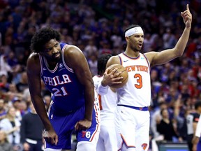 Joel Embiid, left, of the Philadelphia 76ers reacts as Josh Hart of the New York Knicks celebrates a play during the second quarter of Game 6 of the Eastern Conference First Round Playoffs at the Wells Fargo Center on May 2, 2024 in Philadelphia, Pa.