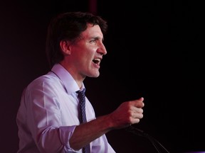 Justin Trudeau speaking against a dark background