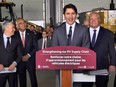 Justin Trudeau smiles at a podium