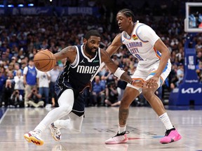 Kyrie Irving, left, of the Dallas Mavericks dribbles by Jalen Williams of the Oklahoma City Thunder during the fourth quarter in Game 3 of the Western Conference Second Round Playoffs at American Airlines Center on May 11, 2024 in Dallas, Texas.