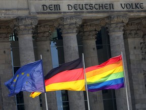The flags of Europe, Germany and a rainbow flag flutter