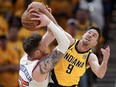 T.J. McConnell of the Indiana Pacers battles Isaiah Hartenstein of the New York Knicks