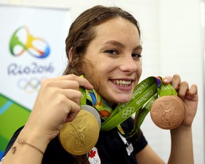 Penny Oleksiak, then 16, shows off her medal haul at the 2016 Olympic Games in Rio de Janeiro, Brazil. While Olesiak is looking to recapture her epic form for the Paris Games, she remains a massive inspiration to Canadian swimmers. Dave Abel/Sun files