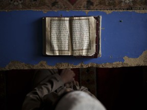A student reads the Quran