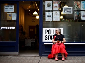 A member of the Labour Party sits outside a polling station