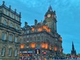 The Balmoral Hotel in Edinburgh seen at night from across the street.