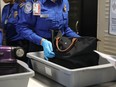 A Transportation Security Administration (TSA) worker screens luggage