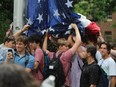 Students at the University of North Carolina helped protect the American flag after protesters took it down to fly Palestinian colours on Tuesday.