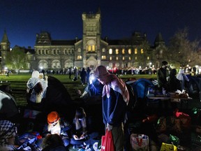 Pro-Palestinian demonstrators prepare supplies at an encampment on the University of Toronto main downtown campus on May 2, 2024.
