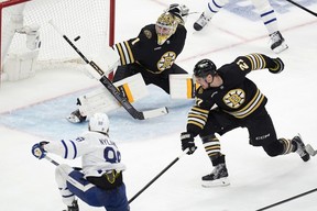 Maple Leafs’ William Nylander (88) scores against Boston Bruins’ Jeremy Swayman (1) as Bruins’ James van Riemsdyk (21) defends to give Toronto a short-lived 1-0 lead in the third period of Game 7 on Saturday. Boston stormed back to win in OT. Michael Dwyer/AP