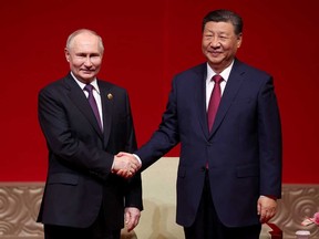 In this pool photograph distributed by the Russian state agency Sputnik, Russia's President Vladimir Putin and China's President Xi Jinping attend a concert marking the 75th anniversary of the establishment of diplomatic relations between Russia and China and opening of China-Russia Years of Culture at the National Centre for the Performing Arts in Beijing on May 16, 2024.