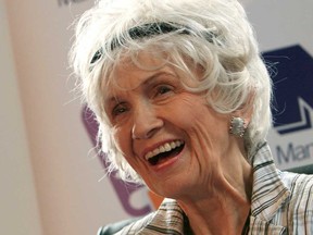 Canadian author Alice Munro holds one of her books as she receives her Man Booker International award at Trinity College Dublin, in Dublin, Ireland, on June 25, 2009.