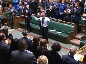 A video grab from footage broadcast by the UK Parliament's Parliamentary Recording Unit (PRU) shows Britain's Conservative MP Craig Mackinlay acknowledging the applauses and cheering, in the House of Commons, in London, on May 22, 2024 on the day of his coming back after both his hands and feet were amputated after he contracted sepsis.