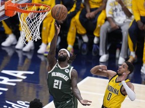 Milwaukee Bucks guard Patrick Beverley (21) drives to the basket past Indiana Pacers guard Tyrese Haliburton (0) during the first half in Game 6 in an NBA basketball first-round playoff series, Thursday, May 2, 2024, in Indianapolis.