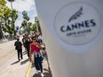 Pedestrians walk on the eve of the opening ceremony of the 77th edition of the Cannes Film Festival in Cannes, southern France, on May 13, 2024.