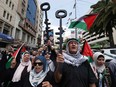 Palestinian protesters hold symbolic keys during a rally in the northern West Bank city of Nablus on May 15, 2024, marking the 76th anniversary of the "Nakba" or "Catastrophe" of the creation of Israel, which sparked the exodus of hundreds of thousands of Palestinians in 1948.
