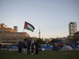 Protesters gather in an encampment set up on the University of Toronto campus in Toronto on Thursday, May 2, 2024. The University of Toronto says it sees "a way forward" after meeting with student protesters behind a pro-Palestinian encampment on campus.THE CANADIAN PRESS/Christopher Katsarov