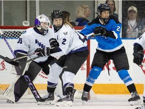Toronto's Natalie Spooner (24) battles for position with Minnesota's Lee Stecklein (2) in front of goaltender Maddie Rooney (35) during third period PWHL action in Toronto on Wednesday May 1, 2024.