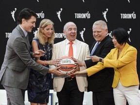 Prime Minister Justin Trudeau (left to right), WNBA Commissioner Cathy Engelbert, Larry Tanenbaum of Kilmer Sports Ventures, Ontario Premier Doug Ford, and Toronto Mayor Olivia Chow pose during a news conference announcing the city's WNBA franchise in Toronto on Thursday, May 23, 2024.