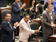NDP MPP Sol Mamakwa brandishes an eagle feather towards the government benches as he stands in the Ontario legislature in Toronto, on Tuesday, May 28, 2024, to speak in his language, Oji-Cree, the first time in history that Indigenous language is used in the provincial legislature to ask a question of the government.