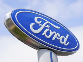 A Ford sign is shown at a dealership