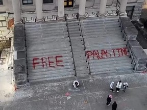 Overhead shot of University of Ottawa building with "FREE PALASTINE" spray-painted on steps.