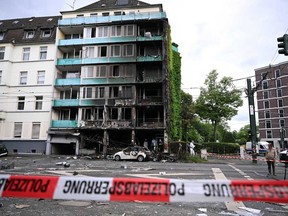 Investigators of the police work in the ruins of a building destroyed by a fire that claimed three lives, on May 16, 2024 in Duesseldorf, western Germany.
