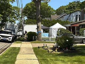 Suffolk County police stand outside the home of Rex Heuermann