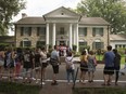 Fans wait in line outside Graceland Tuesday, Aug. 15, 2017, in Memphis, Tenn.