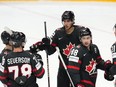 Dylan Cozens, middle, celebrates with teammates