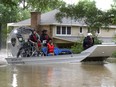 A woman is rescued by airboat from her home